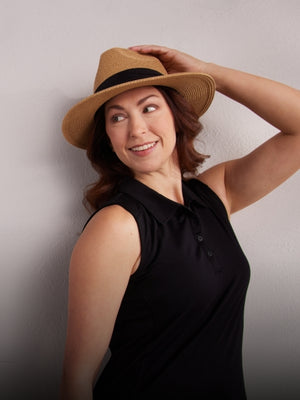 Model wearing black Rosie polo and a hat mobile size