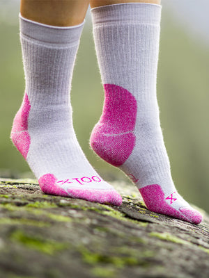 Zoomed image of pebble pink Milo socks being worn on greenery