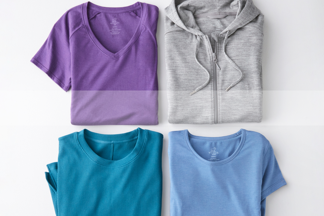 Purple V Neck Tee, Light Grey Zip Up Hoodie, Teal Ribbed Short Sleeve Top, Light Blue Scoop Neck T-Shirt, all folded and laid flat