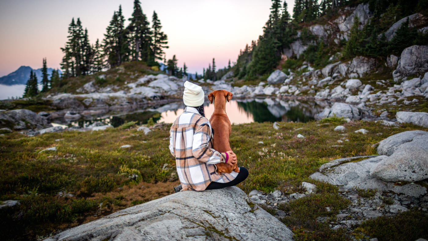 Model Wearing Baylor Beanie and Sawyer Shacket on Rock with Dog