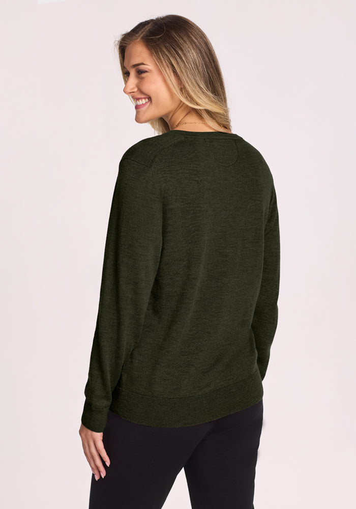 Woman smiling, facing away, in the Woolx Francesca Sweater - Duffel Bag with black pants against a light background.