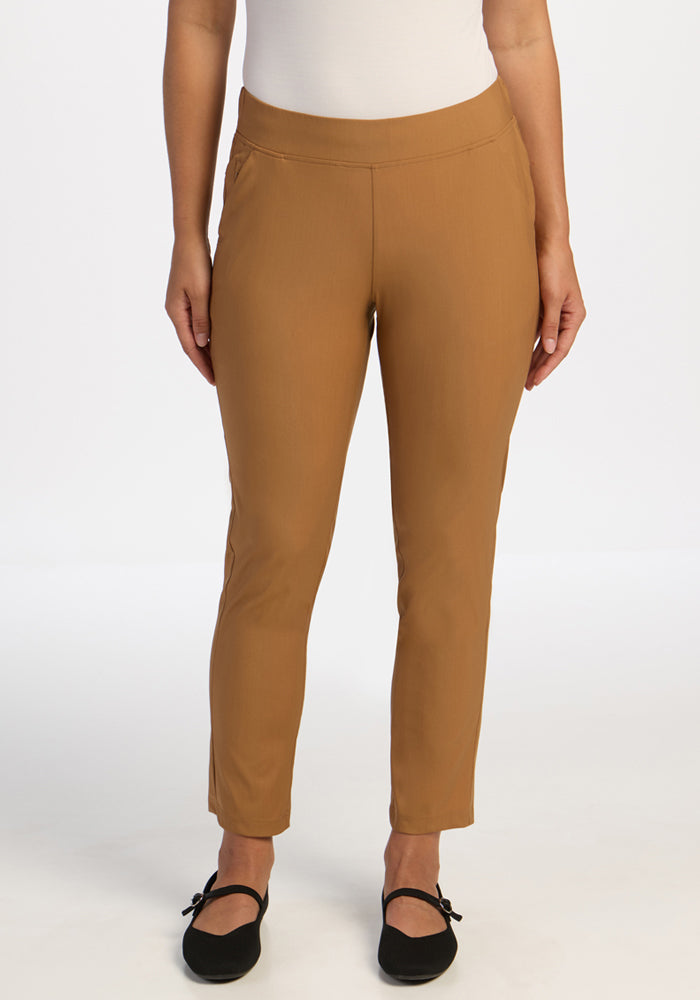 A person wearing Woolx Nicole Ankle Pants in Saddleback with black shoes, standing against a white background. 