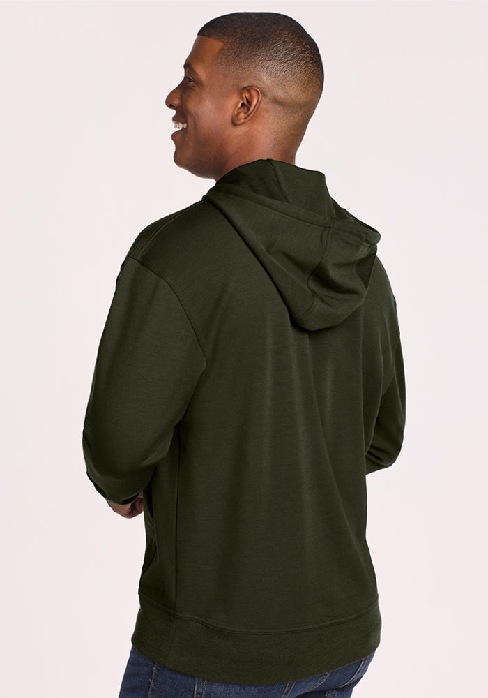 Man faces away, smiling in a Woolx Chase Hoodie - Duffel Bag, against a plain light background.