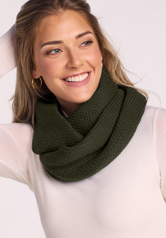 Woman smiles in a Woolx Noelle Infinity Scarf—Duffel Bag, white top; ideal for your winter wardrobe.