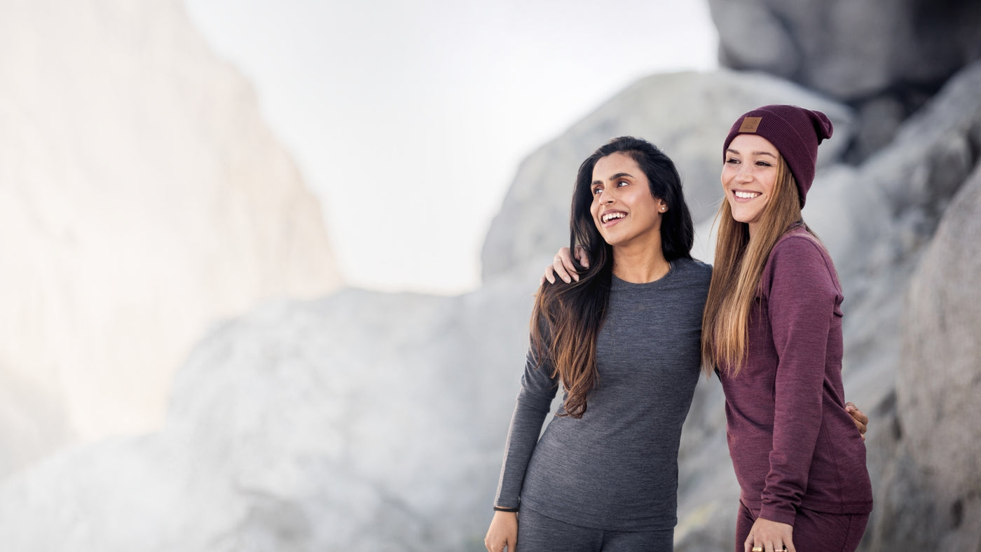 Two women wearing matching sets standing on mountain