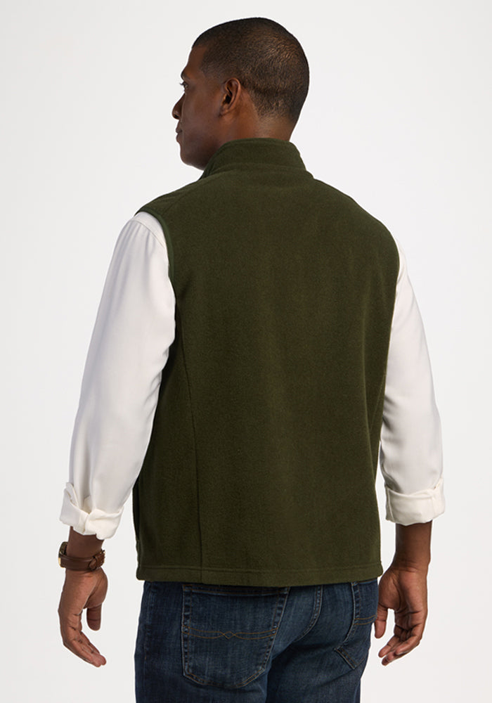 A person seen from the back wearing a heavyweight Everest Vest - Duffel Bag over a white button-down shirt and jeans.