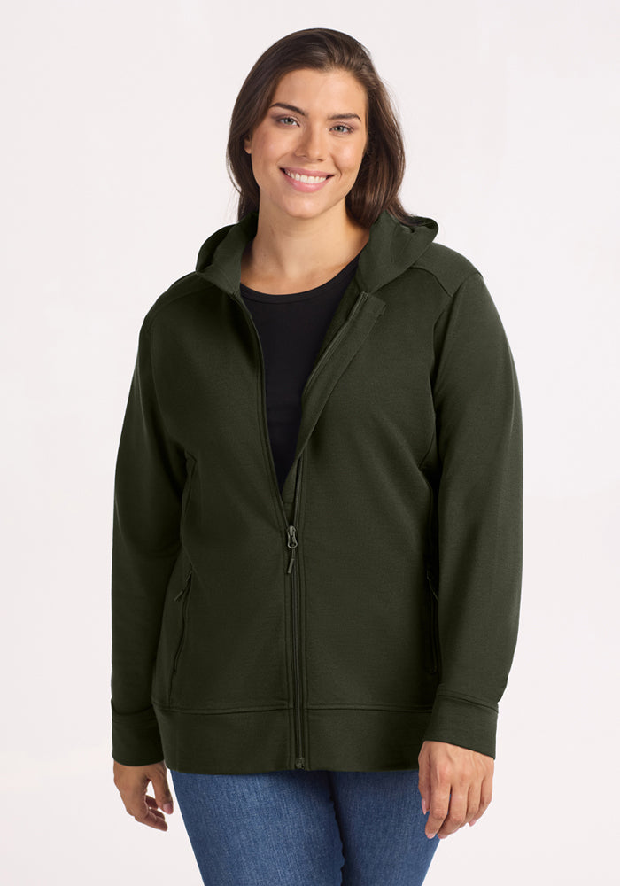 Woman in Woolx Darby Zip Up Hoodie - Duffel Bag, black shirt, and blue jeans, smiling warmly at the camera. 