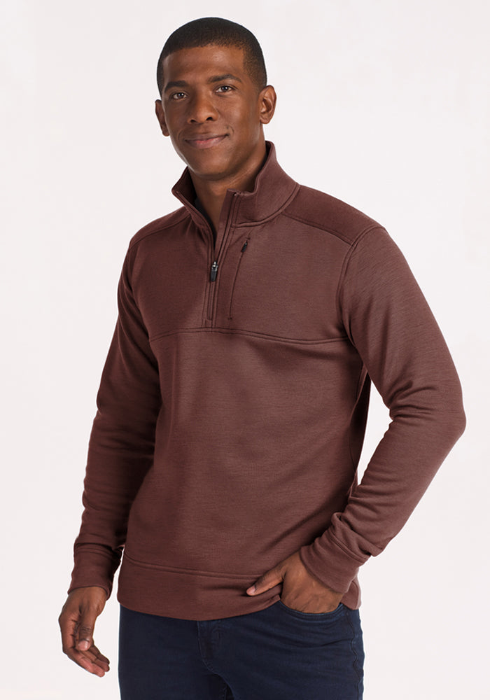 Man in Woolx Mason 1/4 Zip (Canyon Clay), hand in pocket, smiling at camera. 