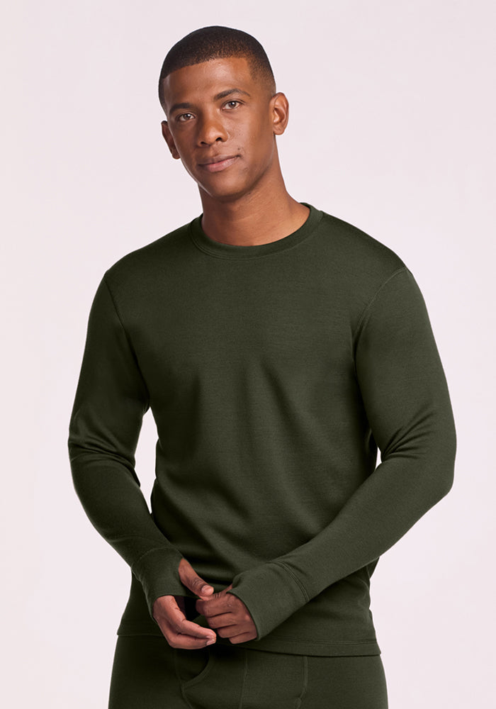 Man in Woolx Glacier Long Sleeve Crew (Duffel Bag), standing against a plain backdrop, facing the camera. 
