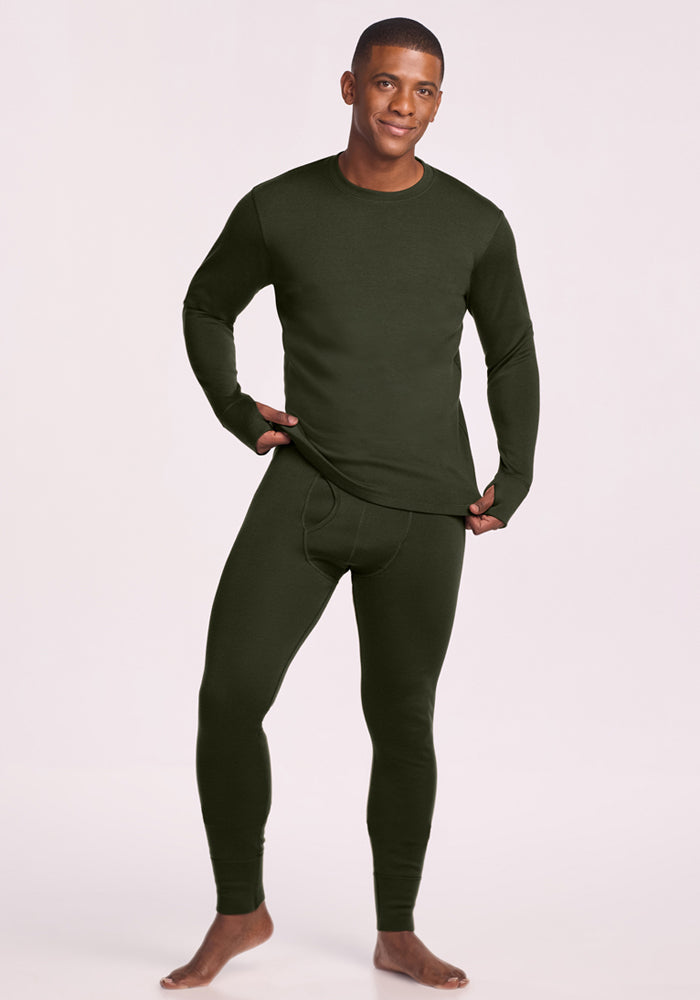 Man in Woolx Glacier Long Sleeve Crew - Duffel Bag and matching leggings, barefoot on a light background.