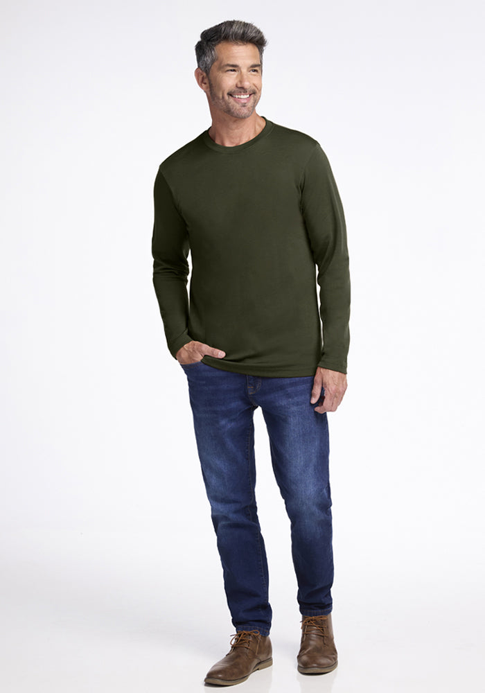 Man in Woolx Easton Crew Neck Shirt - Duffel Bag, blue jeans, and brown shoes stands against a white background.