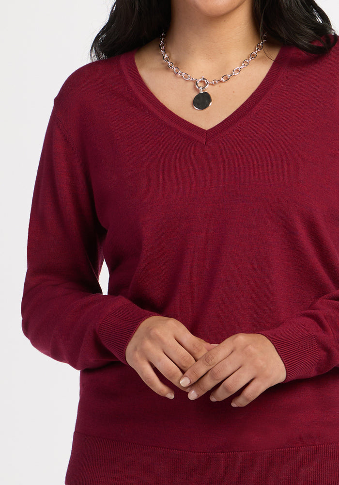 Woman in Woolx Francesca Sweater - Beet Red & silver chain necklace, posing against a white background.