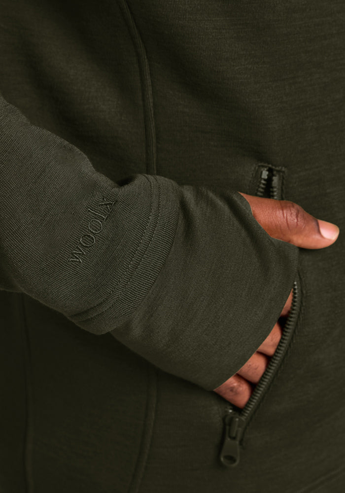 Close-up of a moisture-wicking olive green Woolx Grizzly Sweatshirt - Duffel Bag with a thumbhole cuff and zippered pocket.
