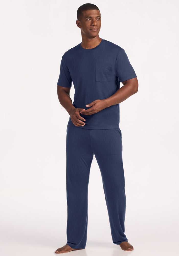A man wearing a moisture-managing navy blue Finn Top - Deep Dive pocket t-shirt and matching lounge pants.