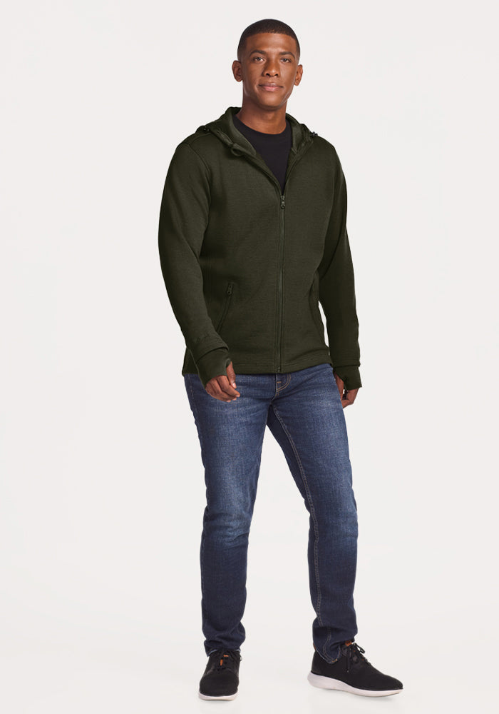A man wearing a Woolx Grizzly Sweatshirt - Duffel Bag, black t-shirt, jeans, and black sneakers.
