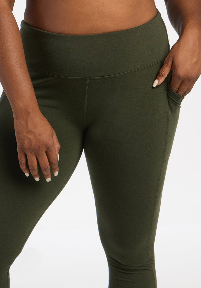 Model in Woolx Piper Pocket Leggings - Duffel Bag, shown waist to mid-thigh with hand near pocket.