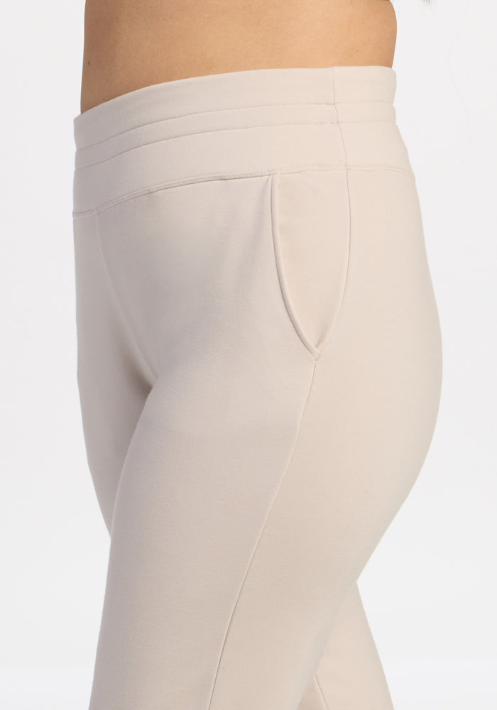Close-up of Woolx Willa Joggers in ecru, shown waist to mid-thigh with side pocket detail.