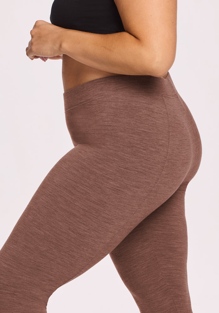 Model wears Woolx Stella Leggings in Sable Heather, side view from upper thighs to midriff, paired with a black top.