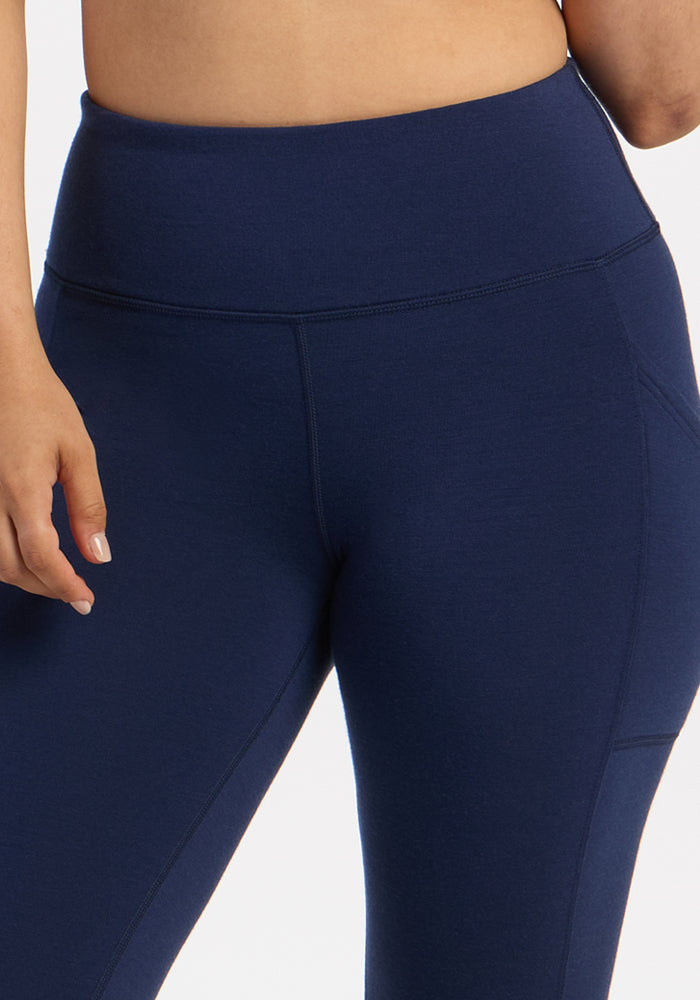 Model in Woolx Piper Pocket Petite - Ocean Cavern leggings, shown waist to mid-thigh, left hand resting by side.