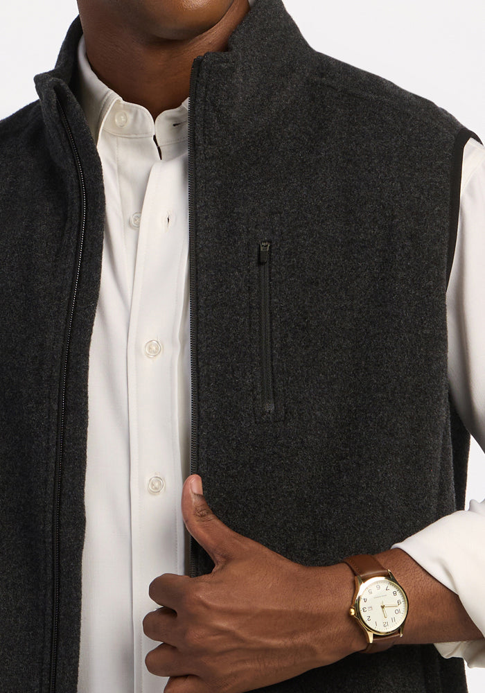 A Woolx Everest Vest - Carbon Black heavyweight merino zip-up worn over a white button-down shirt.