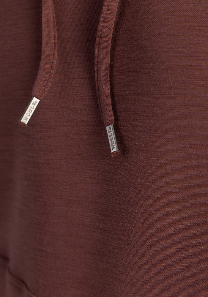 Close-up of the Woolx Watson Pullover in Canyon Clay, featuring metal-capped drawstrings and odor-resistant Merino fabric.