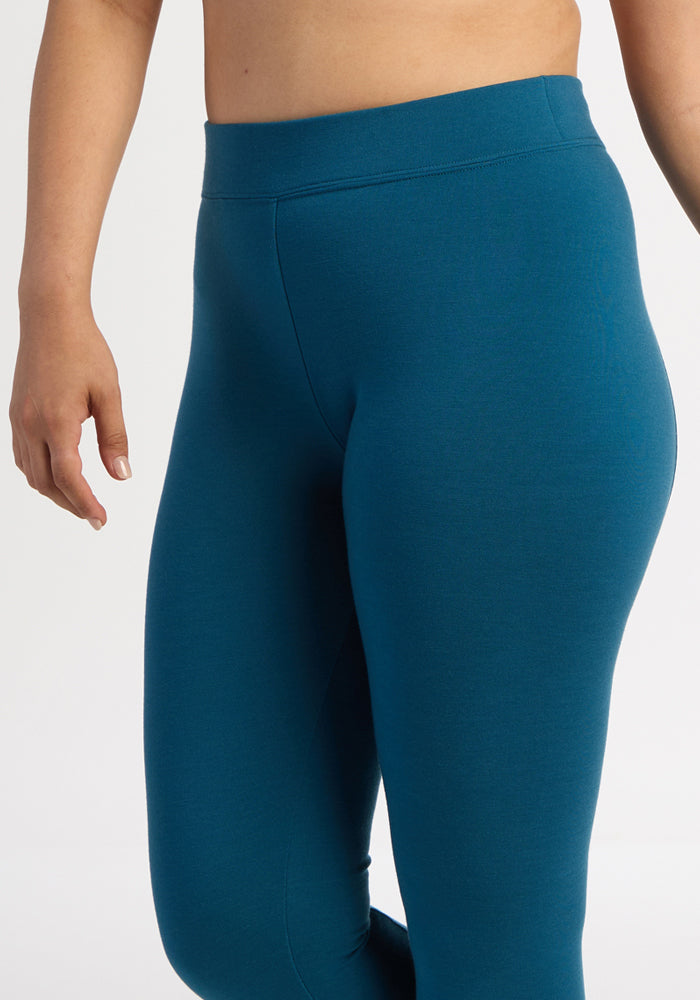 Model in Woolx Stella Leggings - Blue Pine, high-waisted, flattering fit, shown mid-torso to knee on plain background.