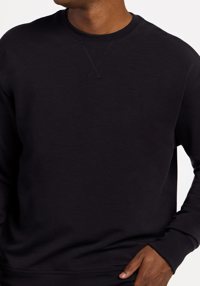 Woolx Miles Crewneck in black with a stitched V-detail at the collar.