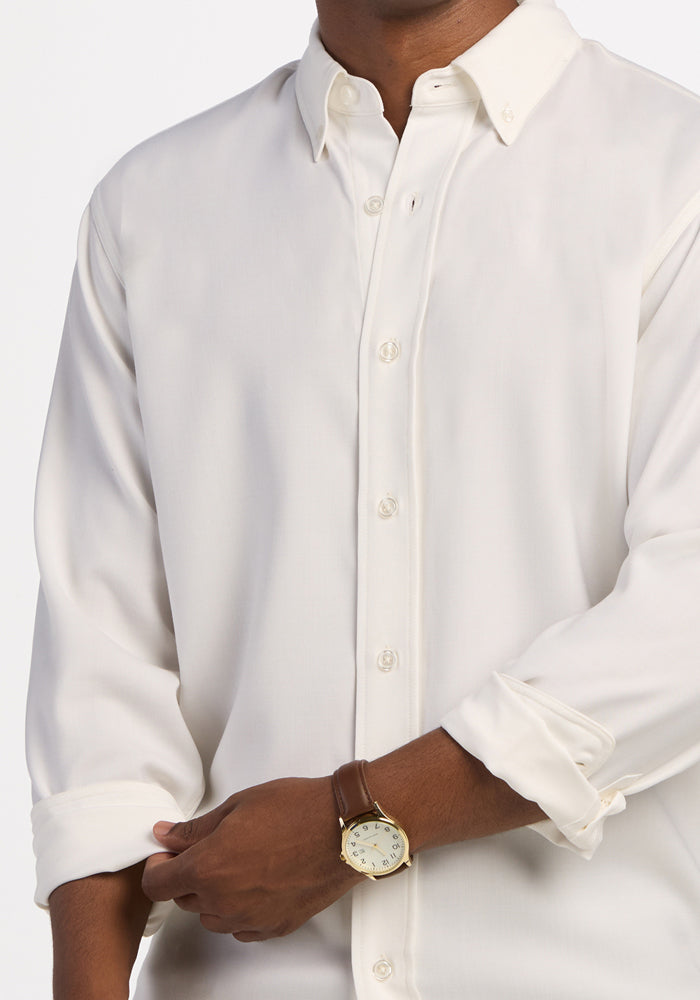 Man in Woolx Nash Button Up - Eggshell rolls up sleeves, flaunting moisture-wicking, odor-resistant qualities.