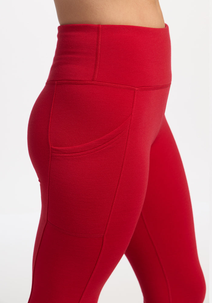 Model in Woolx Piper Pocket Leggings - Maraschino Cherry, high-waisted, waist to mid-thigh, on white background.