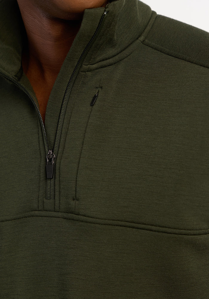 Close-up of a person wearing a Woolx Mason 1/4 Zip - Duffel Bag with a visible quarter zip and high collar.