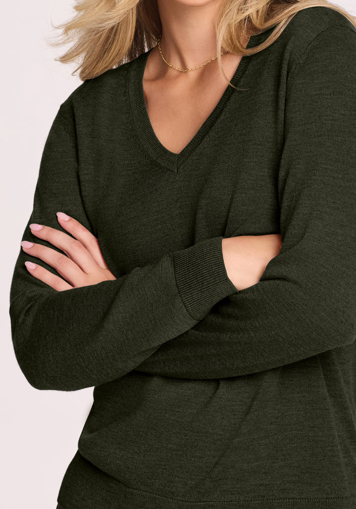 Woman wearing Woolx Francesca Sweater in Duffel Bag, arms crossed, gold necklace, shoulder-length blonde hair.