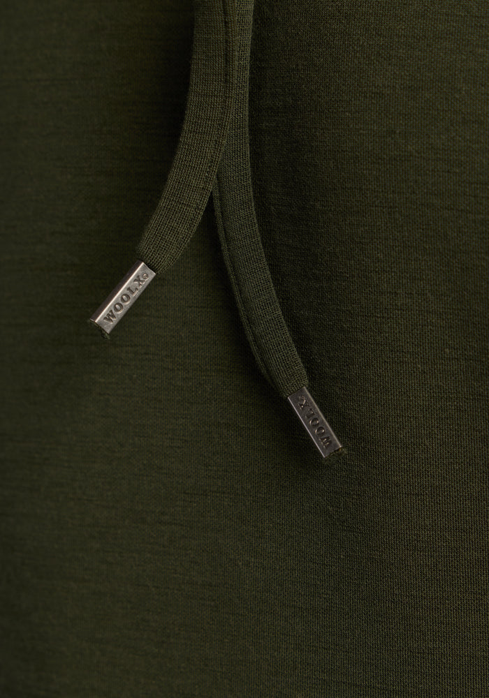 Close-up of Woolx Watson Pullover - Duffel Bag fabric with labeled metal-tipped drawstrings. Odor resistant.