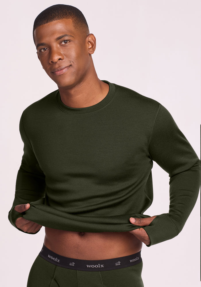 Man lifts Glacier Long Sleeve Crew - Duffel Bag, revealing Woolx odor-resistant merino wool baselayer waistband.