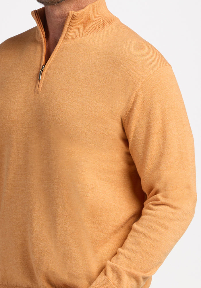 Man wearing Woolx Enzo Quarter Zip in Butterscotch, shown shoulders to waist, on a white background.