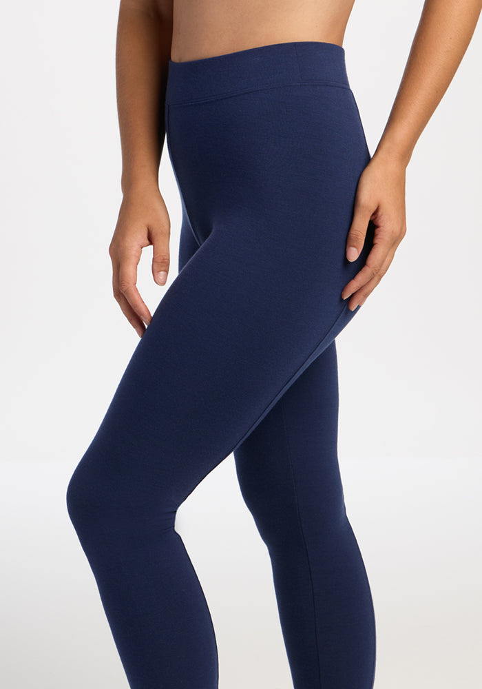 Model wearing Woolx Stella Petite - Ocean Cavern leggings, shown mid-torso to ankles, against a plain background.