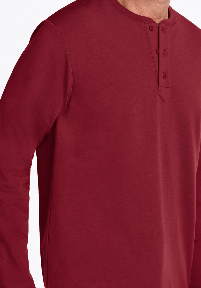 Someone wears the Woolx Jackson Henley - Pinot Noir: soft, stylish, odor-resistant merino wool with three buttons.