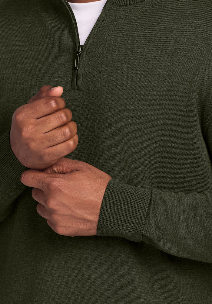 Close-up of a person in the Woolx Enzo Quarter Zip - Duffel Bag, hands clasped—ideal for year-round comfort.