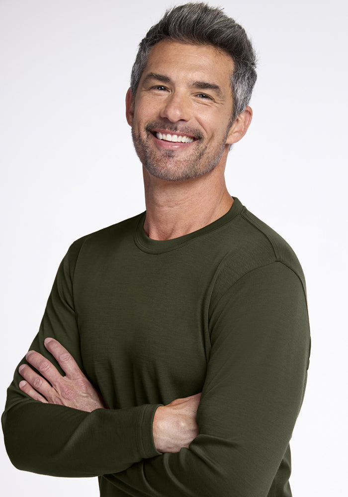 Smiling gray-haired man in a Woolx Easton Crew Neck Shirt - Duffel Bag, arms crossed.