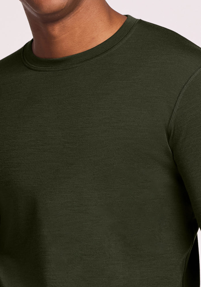 A person in a Woolx Explorer Base Layer - Duffel Bag, shown from shoulders to upper chest.