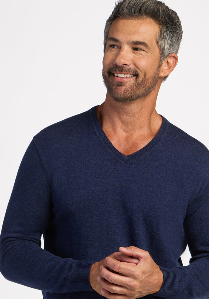 Confident man in Woolx Vincenzo Sweater—Ocean Cavern, a gray-haired classic in men’s essential style.