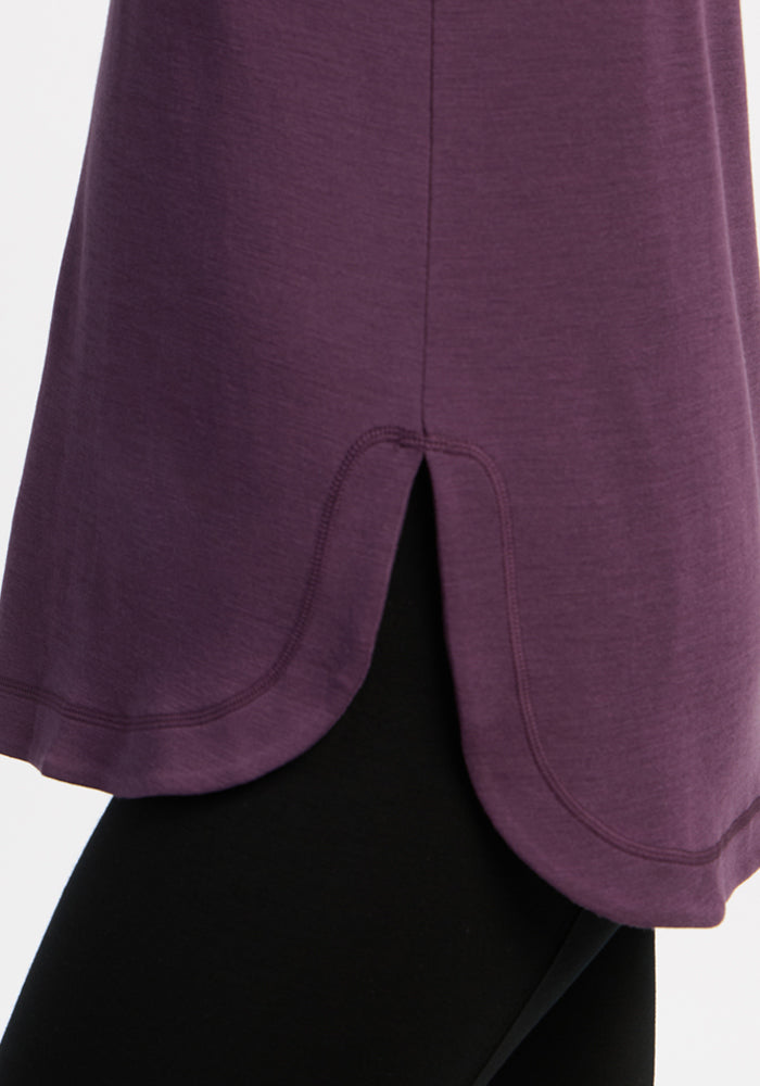 Blair Tunic - Purple Iris by Woolx: ultra-soft wool with curved hem and side slit, styled over black leggings.