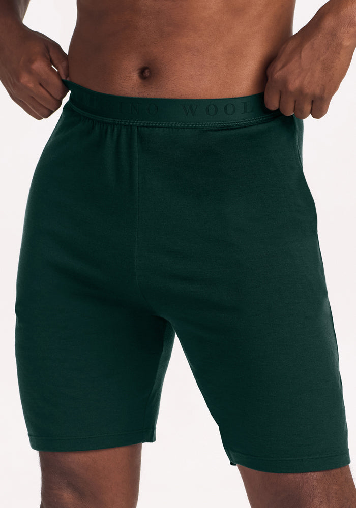 Deep Pine Archer Lounge Shorts in dark green Merino wool with an elastic waistband that reads “MERINO WOOL”.