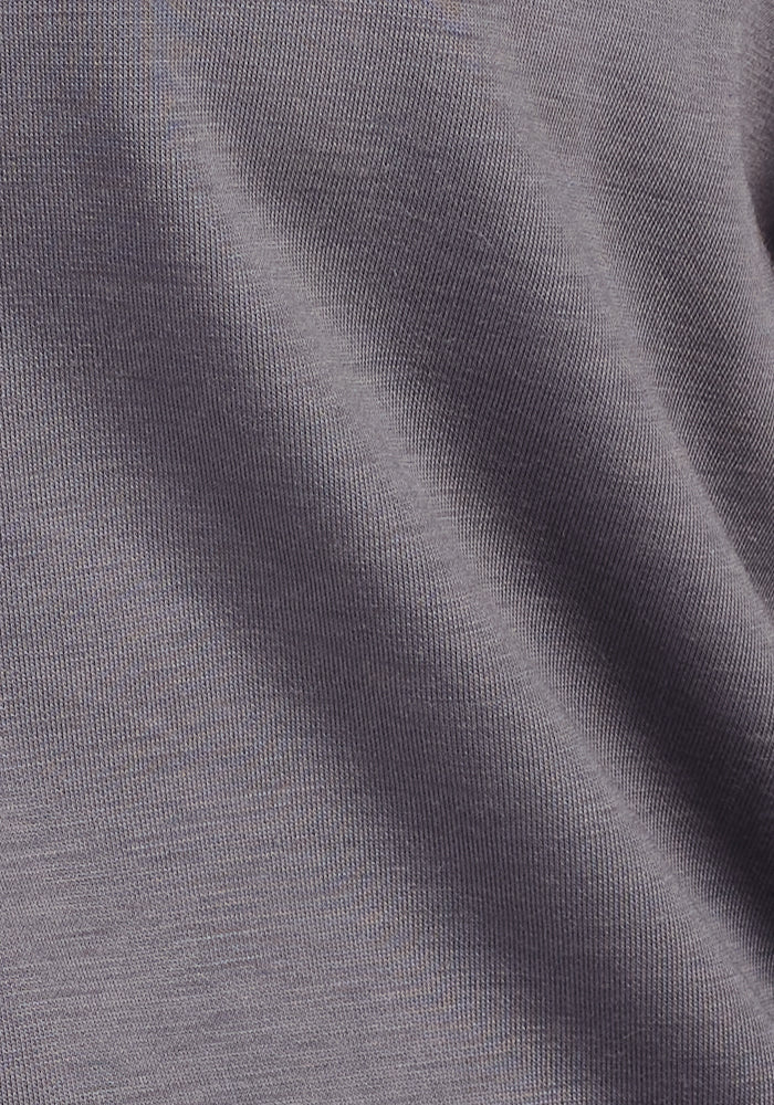 Close-up of the soft, smooth gray fabric of the Woolx Avery Hoodie - Arctic Dusk, showing fine Merino wool knit texture and gentle folds for year-round comfort.