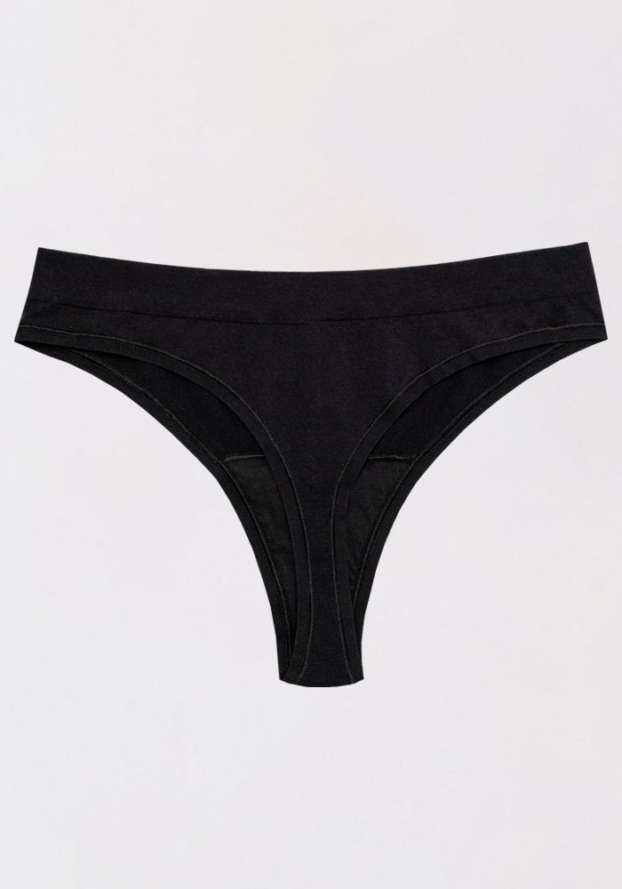 The Woolx Farrah Thong in black, made from moisture-wicking Merino wool, is a seamless women’s underwear showcased against a light gray background.