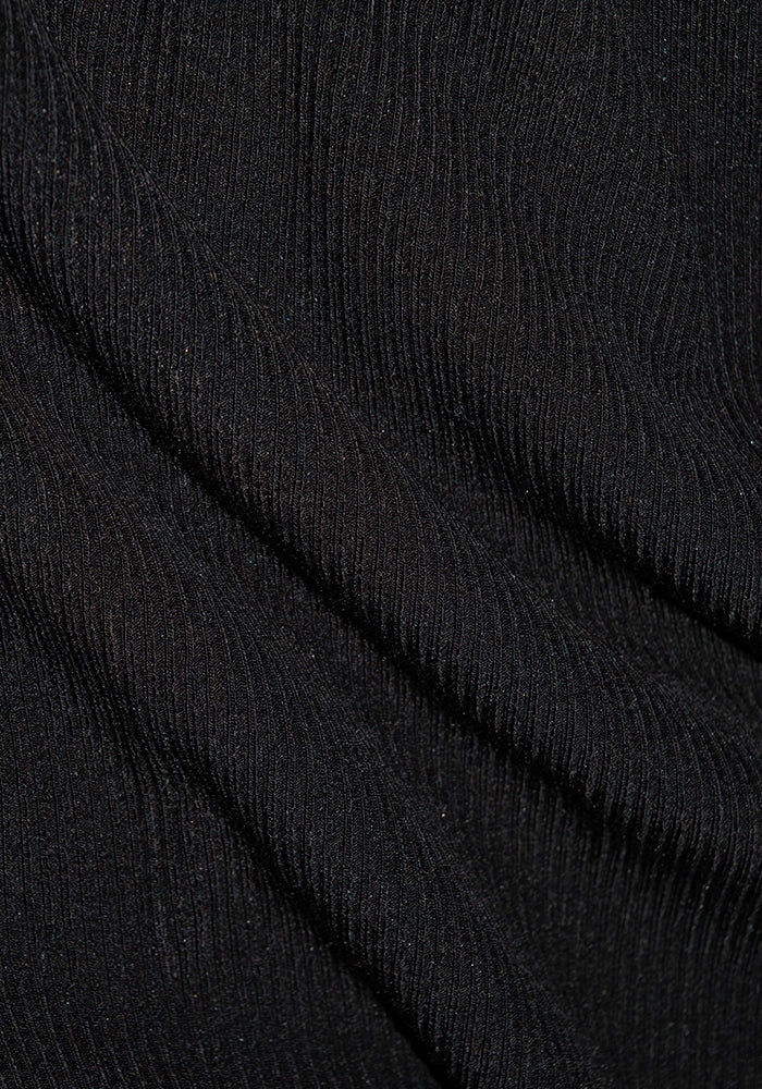 Close-up of Woolx Luca Petite Pants in black Merino wool, showing ribbed texture with fine vertical lines and folds.