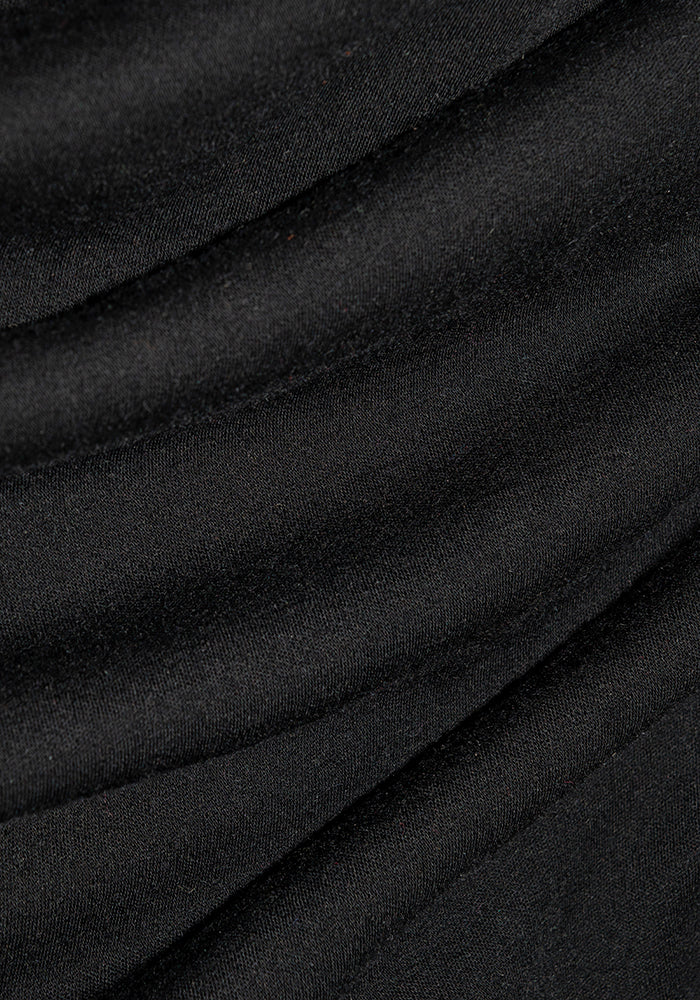 Close-up of Woolx Blair Petite Tunic in black merino wool, showing its soft texture and gentle diagonal folds.