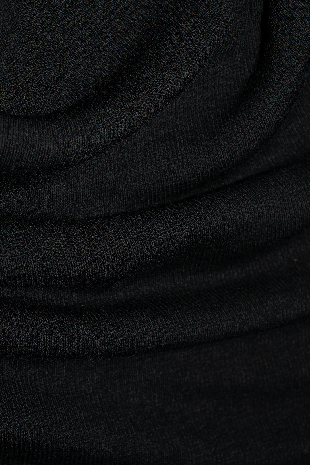 Close-up of Woolx Katie Ribbed Long Sleeve in black merino wool, ultra-soft, odor-resistant, with visible ribbed texture.