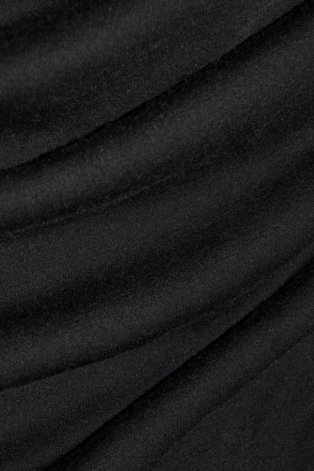 Close-up of Woolx Hannah Petite Long Sleeve Top - Black, showing moisture-wicking fabric’s soft folds and texture.