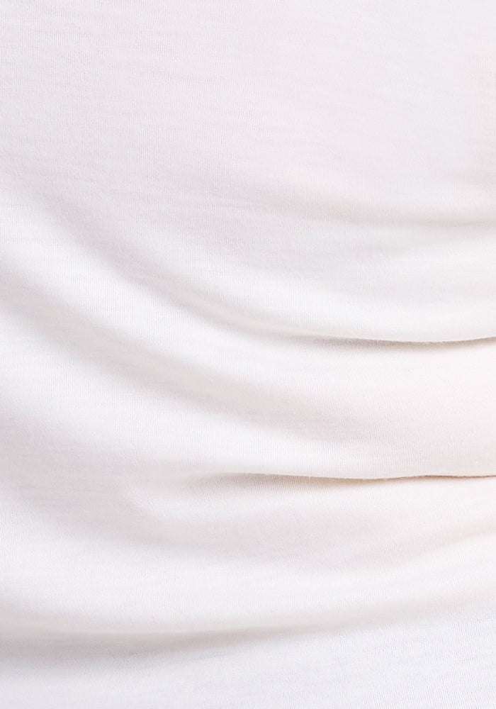 Close-up of Woolx Hannah Petite Long Sleeve Top in Buttercream, showing soft, smooth fabric with gentle folds.