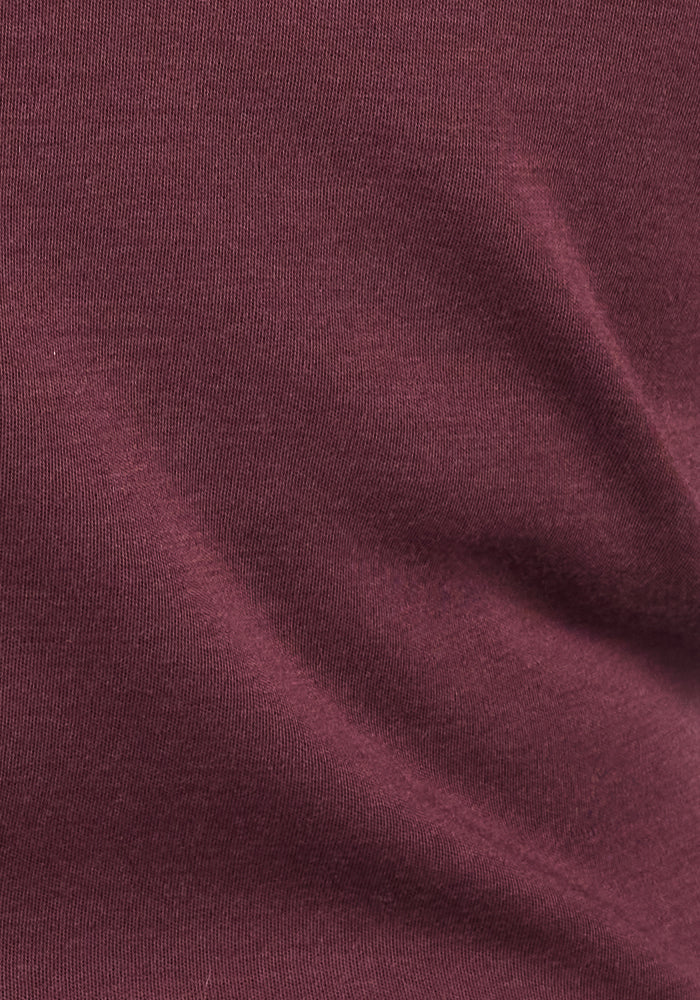 Close-up of the Woolx Hannah Long Sleeve Top in Chocolate Fig, crafted from soft merino wool with a smooth texture and subtle folds—moisture-wicking and perfect for temperature-regulating comfort in any outfit.